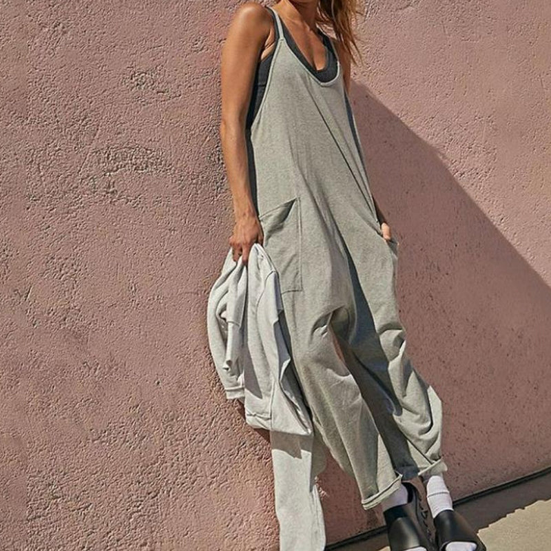 Ensfarget jumpsuit med V-hals slyngelomme