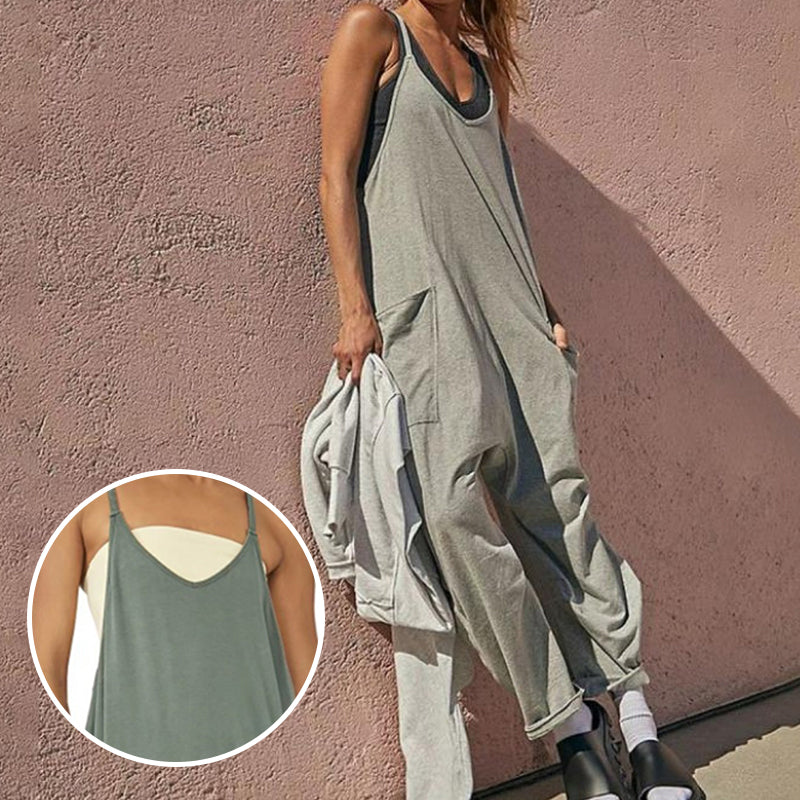 Ensfarget jumpsuit med V-hals slyngelomme